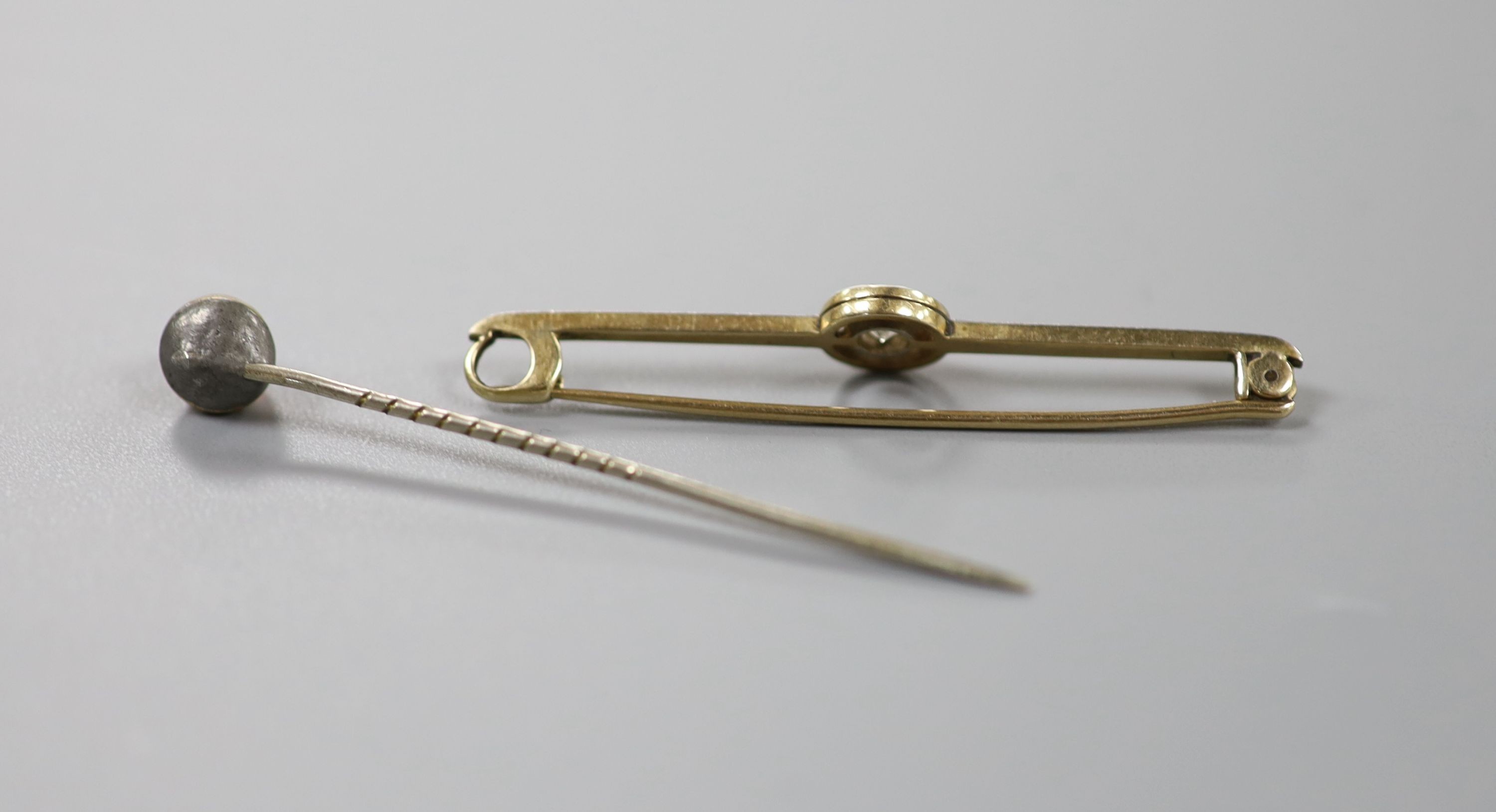 A yellow metal and solitaire diamond set bar brooch, 50mm and a single stone opal set stick pin.